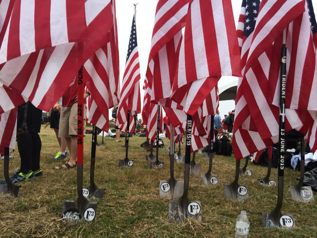F3 PAX carrying shovel flags during a mud run